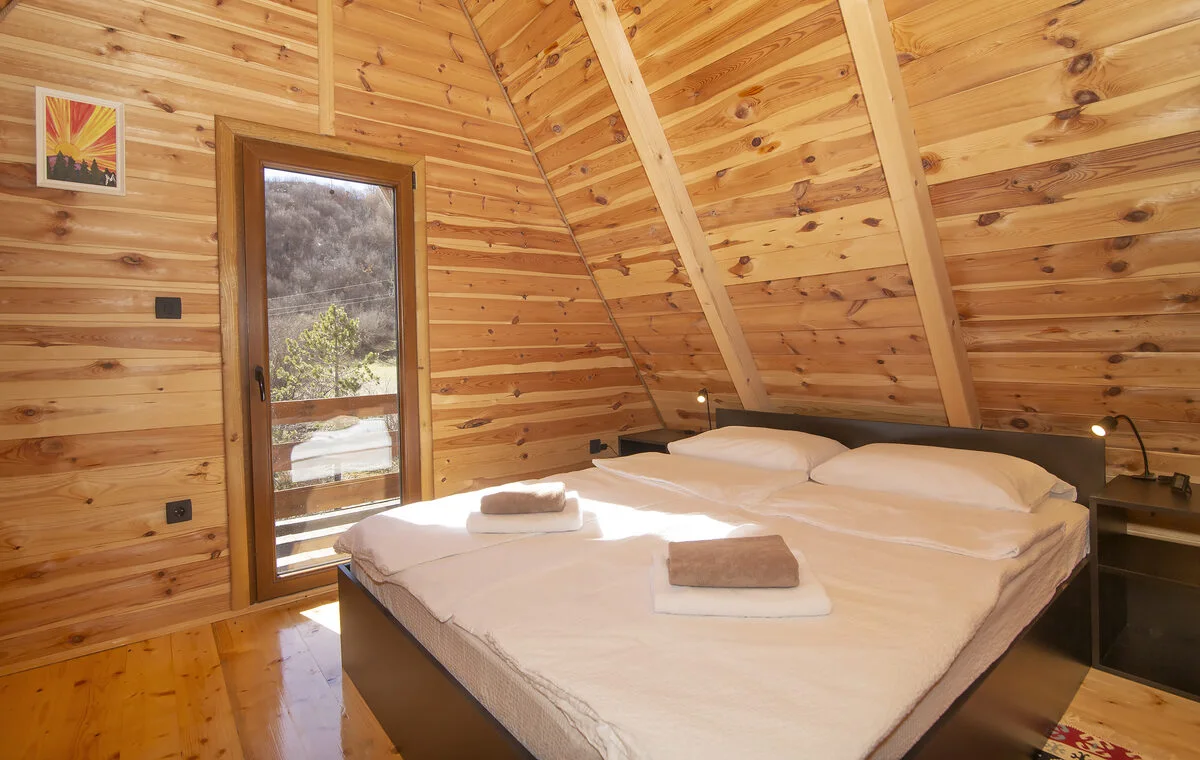 Bedroom inside the GrahovoHomes wooden cabin